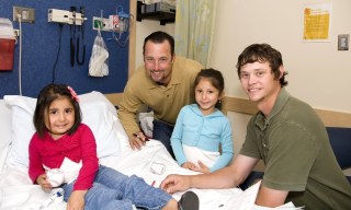 Jimmy Fund co-captains Tim Wakefield and Clay Buchholz with two young Dana-Farber patients